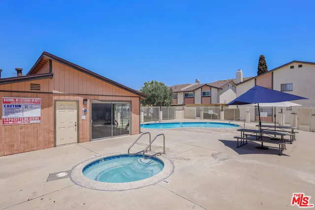 a backyard of a house with table and chairs
