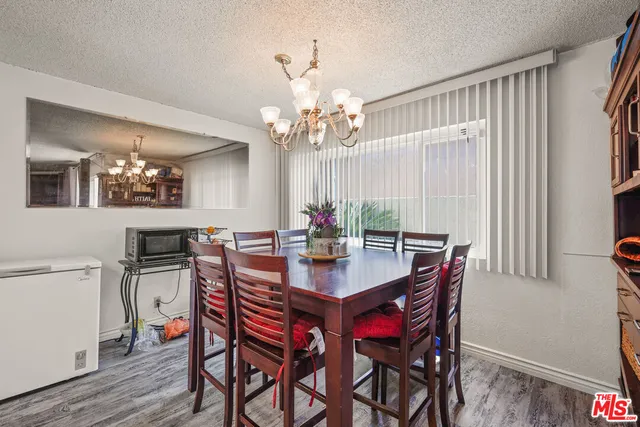 a view of a dining room with furniture and a chandelier