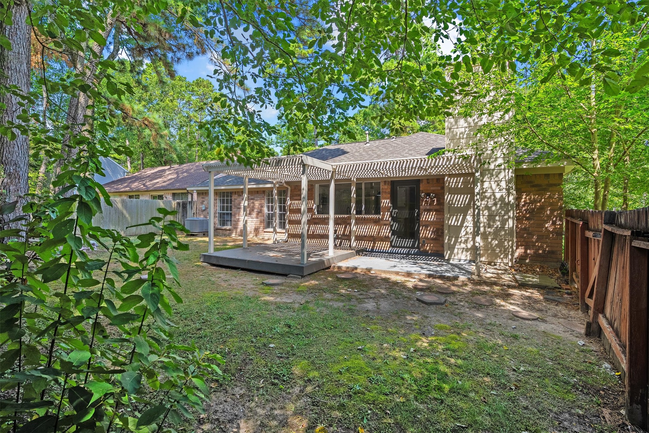 3 Still Corner Place Spring, TX 77381 - Photo 26 of 34 Here's the full picture, a fully fenced backyard wrapped in mature trees, giving you privacy and that true retreat feeling right outside your back door.