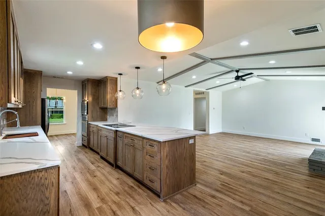 a view of a house with a yard and large tree