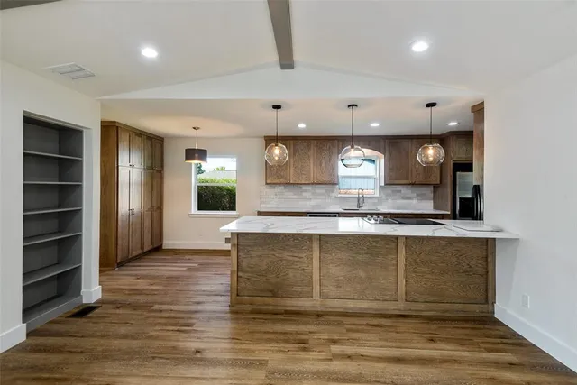 a view of a house with a large window and wooden fence
