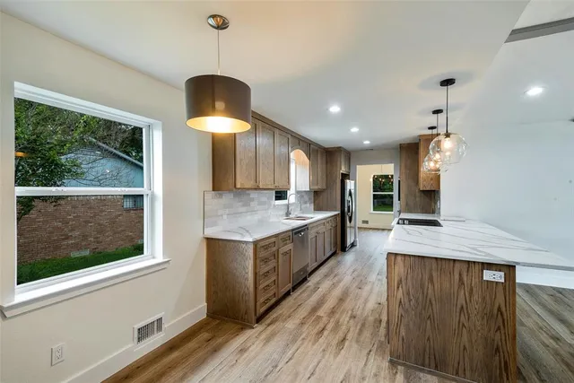 a kitchen with wooden cabinets and a sink