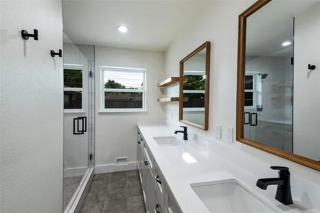 a kitchen with stainless steel appliances granite countertop a sink and a refrigerator