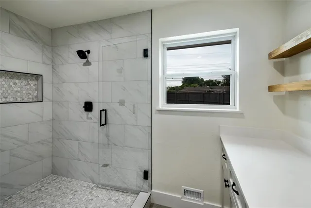 a large kitchen with kitchen island a counter space a sink and a stove