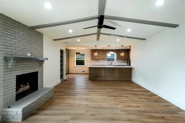 a view of a backyard with a large tree and wooden fence