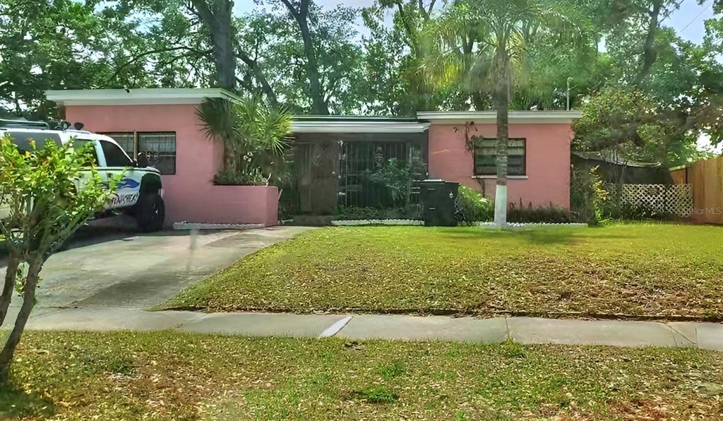 a view of a house with a yard and a patio