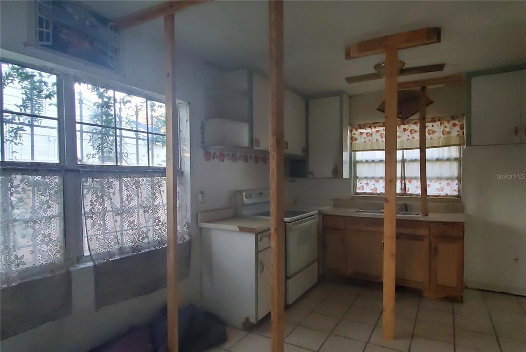 2208 Valencia Road Orlando, FL 32803 - Photo 18 of 45 a kitchen with stainless steel appliances granite countertop a sink and a stove