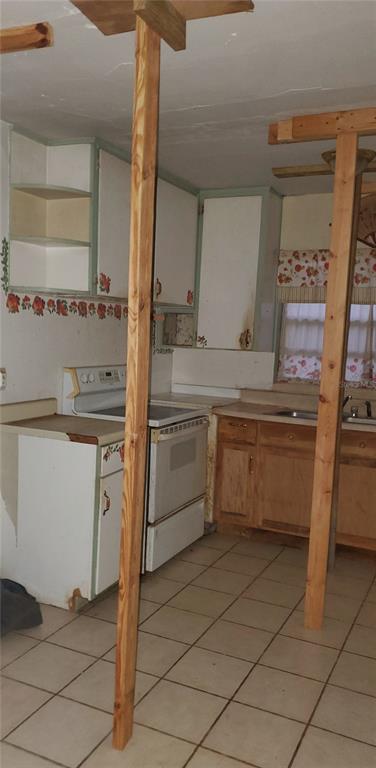 2208 Valencia Road Orlando, FL 32803 - Photo 25 of 45 a kitchen with a stove sink and cabinets