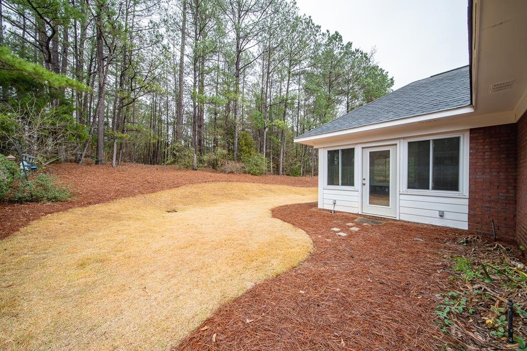 4571 Carnoustie Lane Columbus, GA 31909 - Photo 11 of 49 a front view of a house with a yard and trees