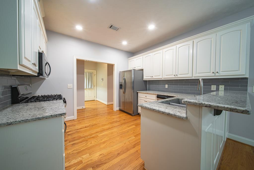 4571 Carnoustie Lane Columbus, GA 31909 - Photo 21 of 49 a kitchen with stainless steel appliances granite countertop a stove a sink and a refrigerator
