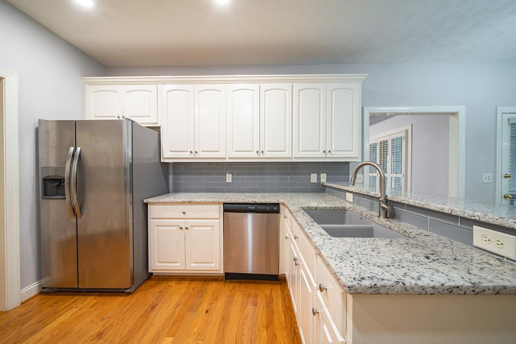 4571 Carnoustie Lane Columbus, GA 31909 - Photo 22 of 49 a kitchen with stainless steel appliances granite countertop a sink stove and refrigerator