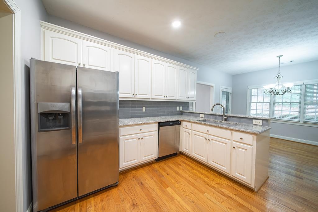 4571 Carnoustie Lane Columbus, GA 31909 - Photo 25 of 49 a modern kitchen with stainless steel appliances granite countertop a stove a sink and a refrigerator