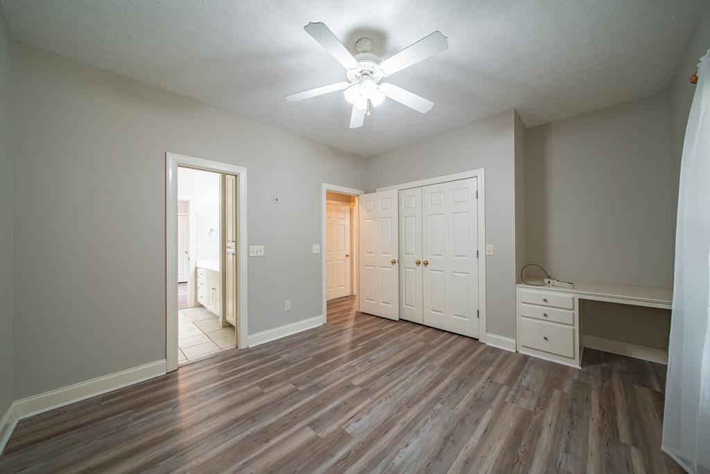 4571 Carnoustie Lane Columbus, GA 31909 - Photo 30 of 49 an empty room with wooden floor and a ceiling fan