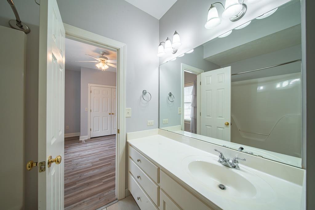 4571 Carnoustie Lane Columbus, GA 31909 - Photo 32 of 49 a bathroom with a double vanity sink a mirror and a shower