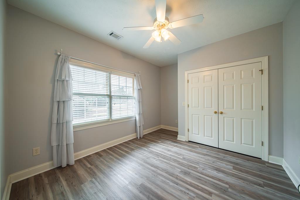 4571 Carnoustie Lane Columbus, GA 31909 - Photo 33 of 49 an empty room with wooden floor and windows