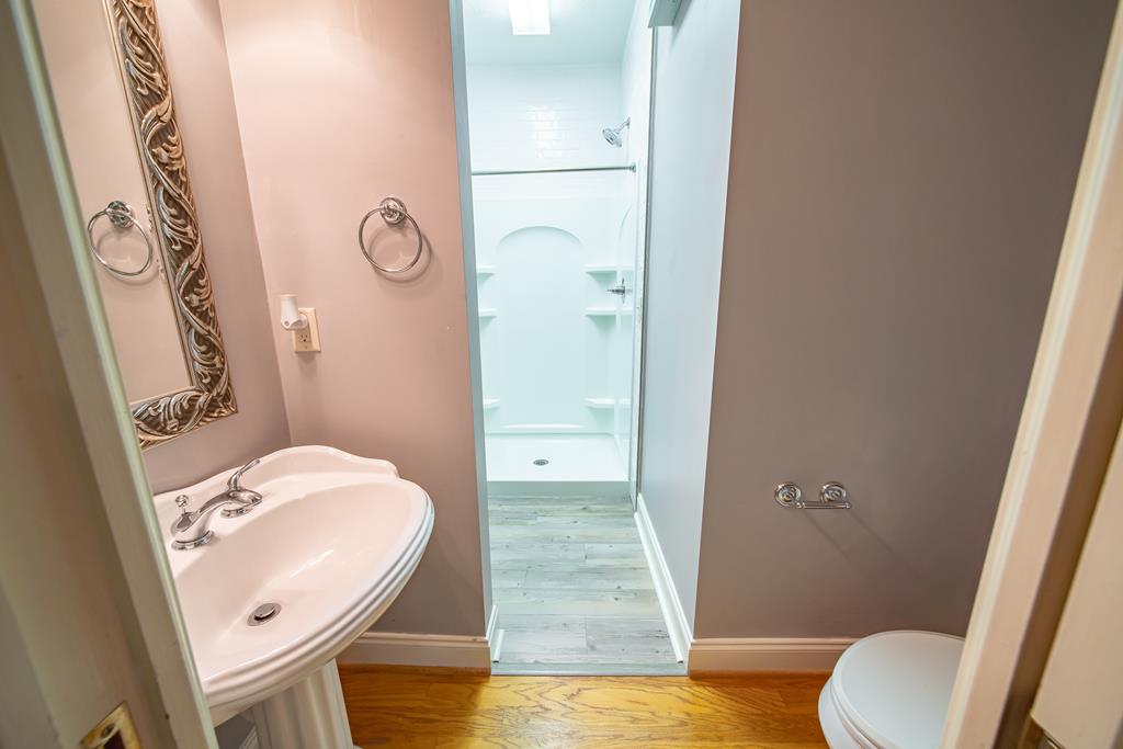 4571 Carnoustie Lane Columbus, GA 31909 - Photo 38 of 49 a bathroom with a sink a toilet a mirror and shower
