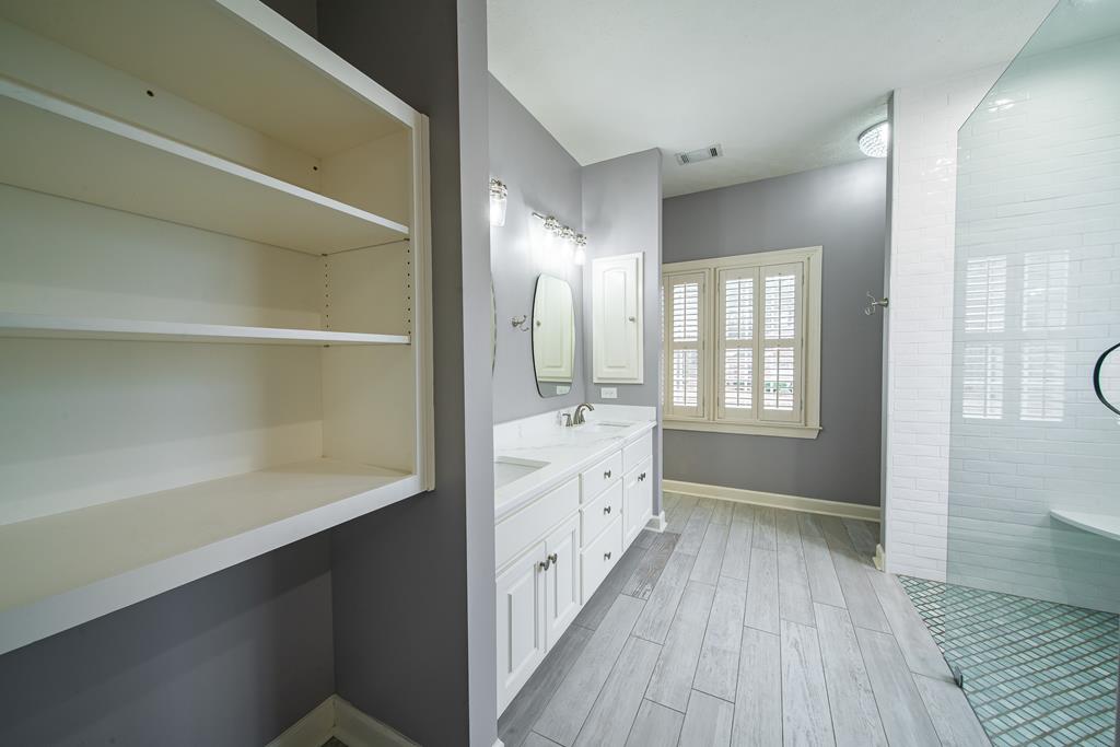 4571 Carnoustie Lane Columbus, GA 31909 - Photo 43 of 49 a bathroom with a double vanity sink and a mirror