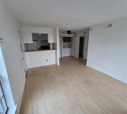 a view of a kitchen with refrigerator and dishwasher