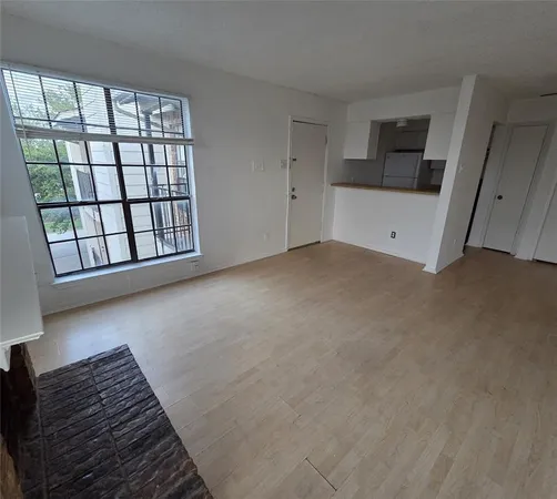 a view of a livingroom with an empty space and wooden floor