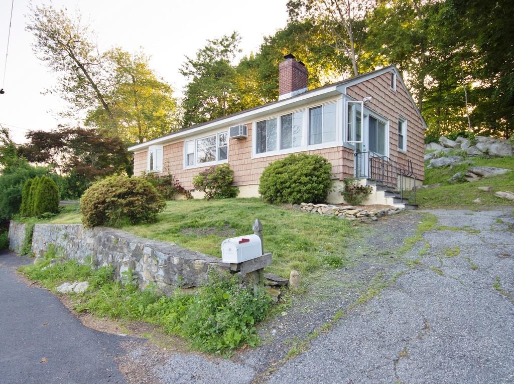 Single story home featuring a chimney and a front yard