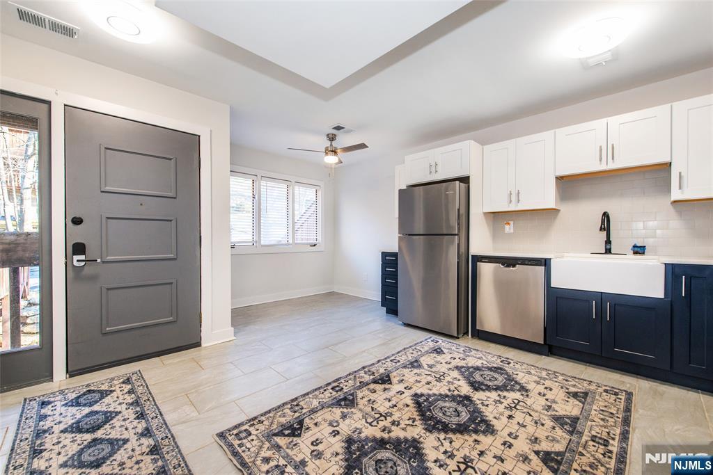 15 Village Way, Unit 5 Vernon, NJ 07462 - Photo 1 of 22 a kitchen with a refrigerator and a sink