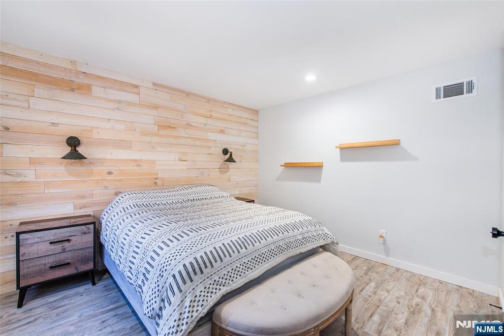 15 Village Way, Unit 5 Vernon, NJ 07462 - Photo 17 of 22 a bedroom with a bed and a night stand