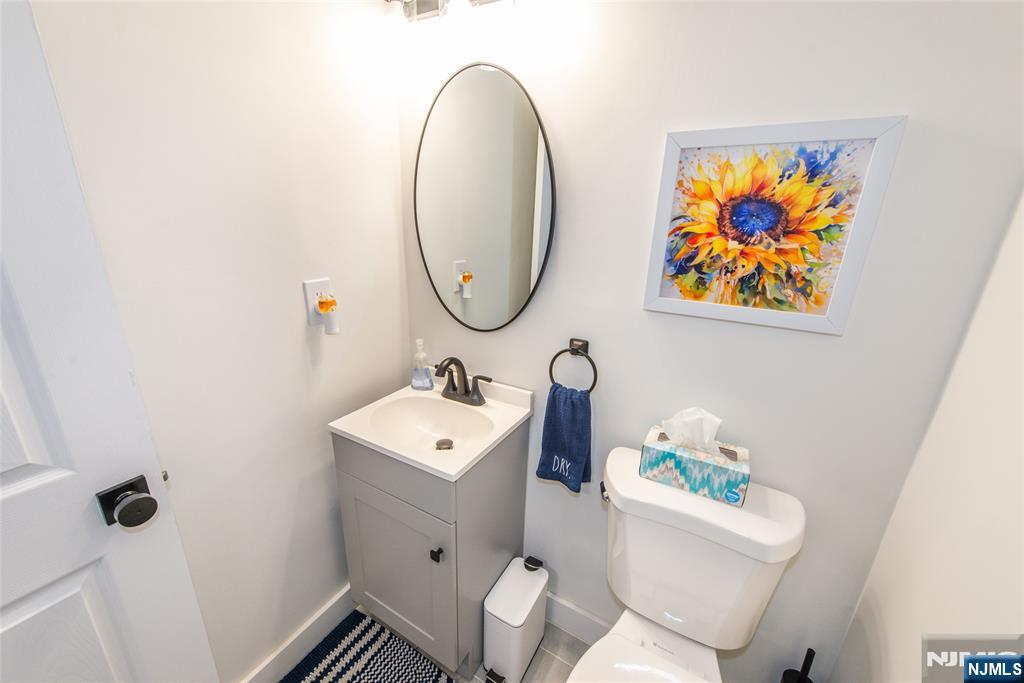 15 Village Way, Unit 5 Vernon, NJ 07462 - Photo 5 of 22 a bathroom with a toilet a sink and a mirror