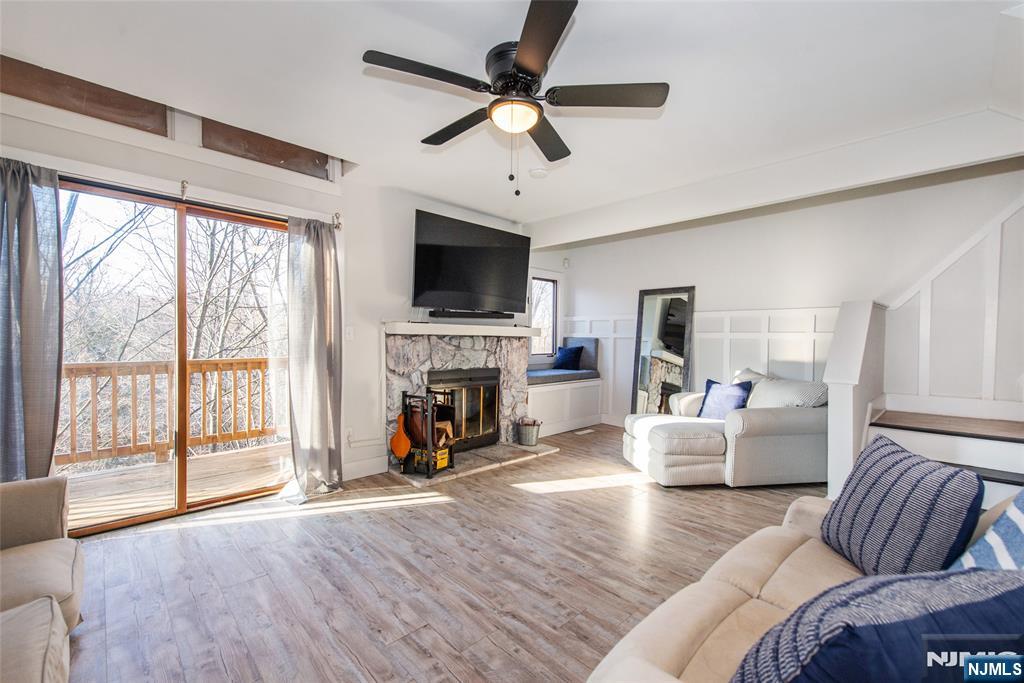 15 Village Way, Unit 5 Vernon, NJ 07462 - Photo 7 of 22 a living room with furniture a fireplace and a flat screen tv