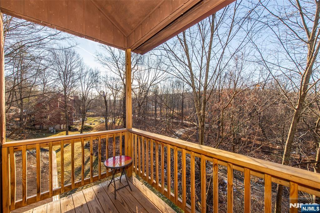 15 Village Way, Unit 5 Vernon, NJ 07462 - Photo 8 of 22 a view of a balcony with wooden fence