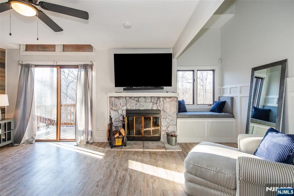 15 Village Way, Unit 5 Vernon, NJ 07462 - Photo 9 of 22 a living room with furniture a flat screen tv and a fireplace