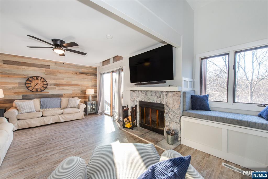 15 Village Way, Unit 5 Vernon, NJ 07462 - Photo 10 of 22 a living room with furniture a fireplace and a flat screen tv
