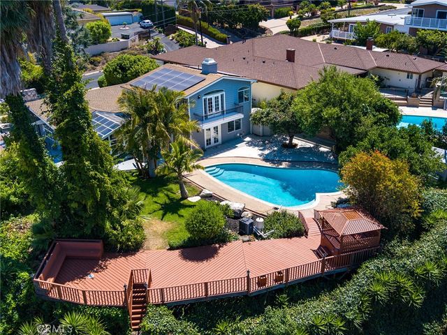 an aerial view of a house with garden space and street view