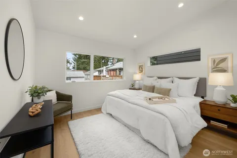 a bedroom with a bed and wooden floor