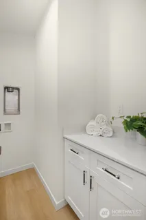 a bedroom with a bed and a potted plant