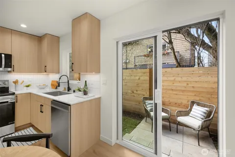 a kitchen with a sink cabinets and dining table