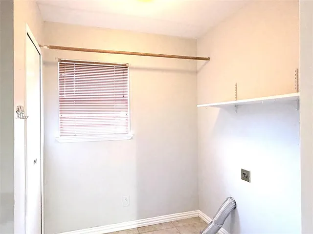 a view of small space with wooden floor and a window