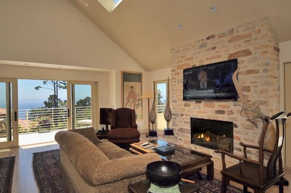 1600 Viscaino Road Pebble Beach, CA 93953 - Photo 8 of 11 a living room with furniture a flat screen tv and a fireplace