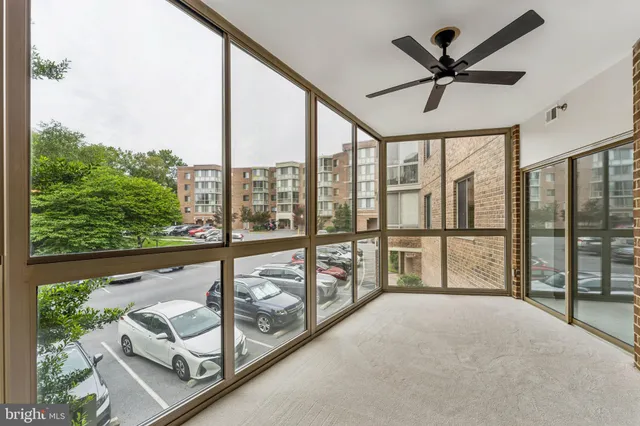a view of a living room and balcony with furniture