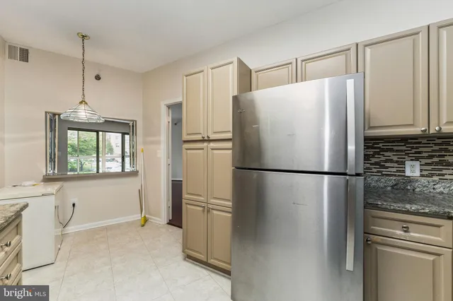 a white refrigerator freezer sitting in a kitchen