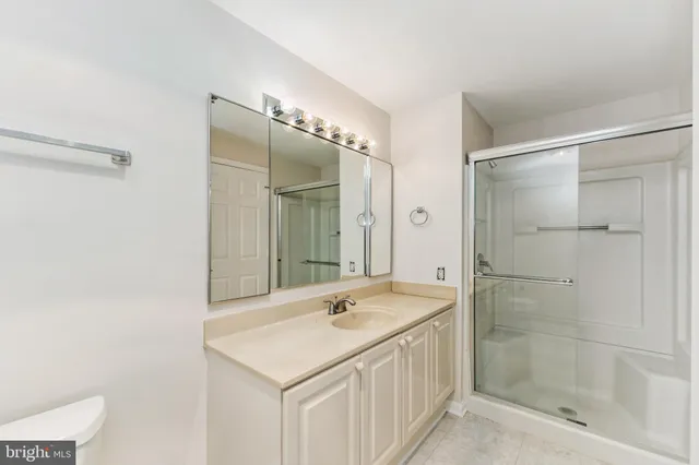 a bathroom with a shower sink and mirror