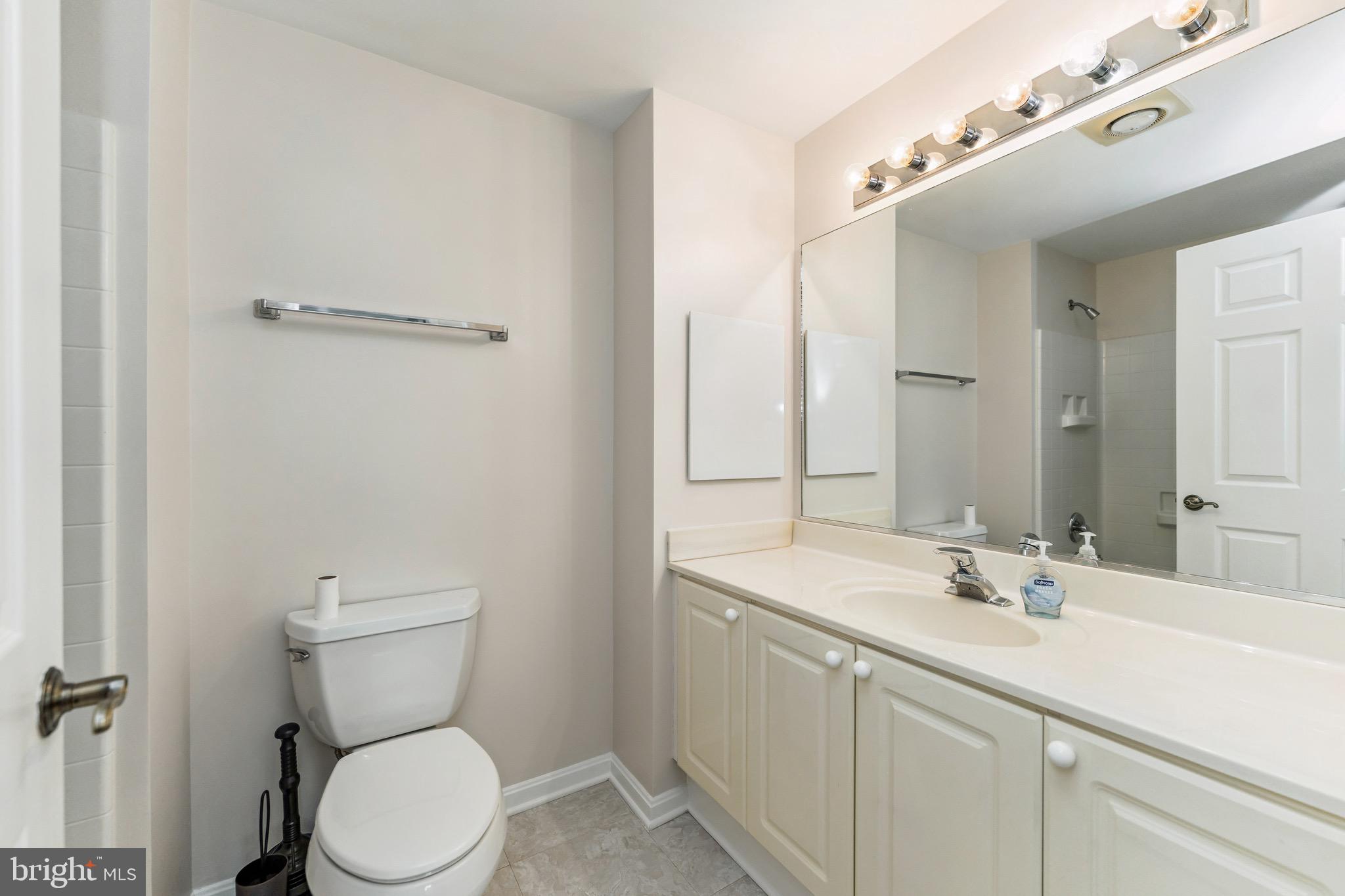 2900 North Leisure World Boulevard, Unit 209 Silver Spring, MD 20906 - Photo 23 of 24 a bathroom with a sink a toilet and mirror