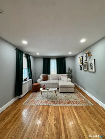 a living room with furniture and a rug