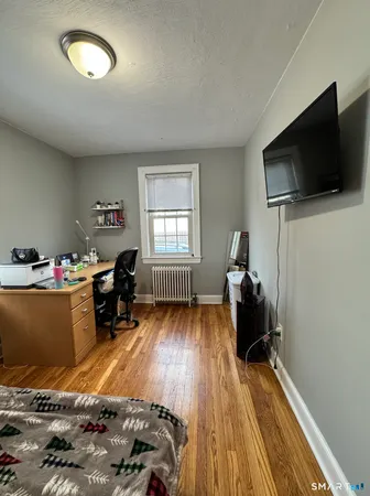 a bed room with furniture and a flat screen tv