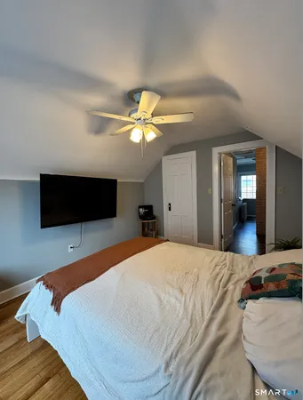 a bedroom with a bed and a flat screen tv