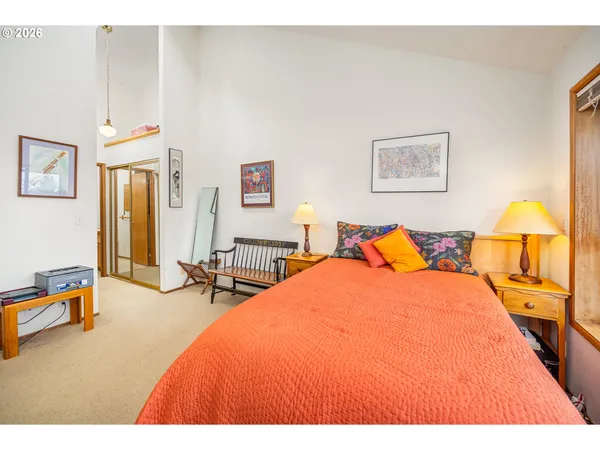 a bathroom with a granite countertop sink a toilet a mirror a bathtub and shower