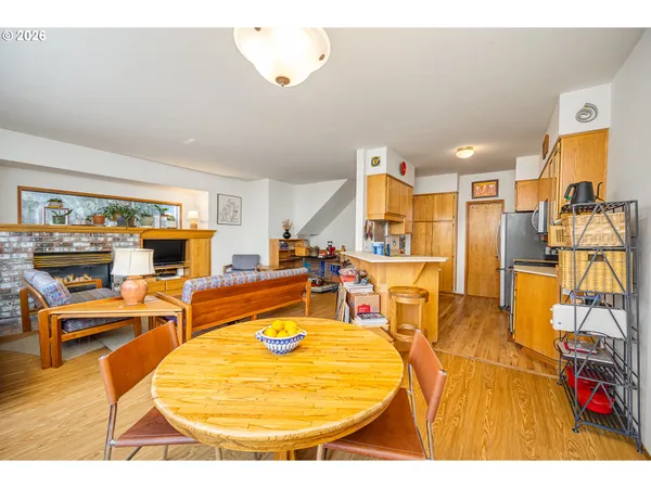 a view of a kitchen with stainless steel appliances granite countertop a sink and cabinets