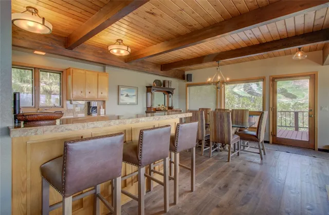 a kitchen with a table chairs and wooden floor