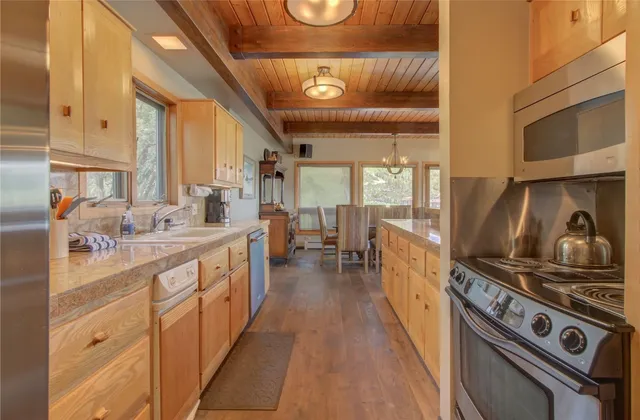 a kitchen with stainless steel appliances granite countertop a stove and a sink