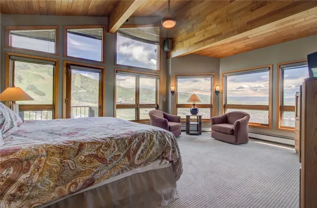 a bedroom with furniture and large windows