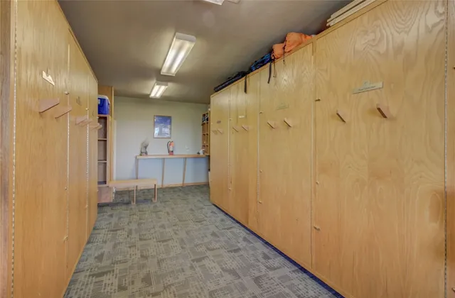 a view of a hallway with wooden shelves